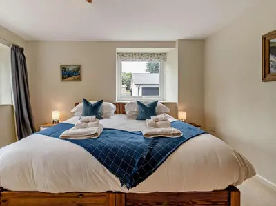 a bedroom with a large bed with towels on it at 6 Bed in Brecon oc-bn171 in Llanspyddid