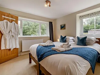 a bedroom with a bed with towels on it at 6 Bed in Brecon oc-bn171 in Llanspyddid