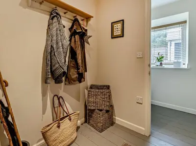 a hallway with a coat rack and a basket at 6 Bed in Brecon oc-bn171 in Llanspyddid