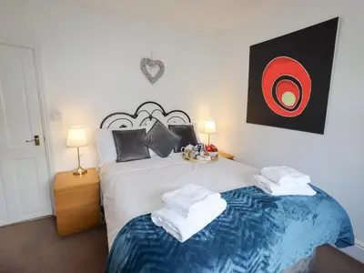 a bedroom with a bed with two towels on it at No 9 On The Riverbank in Llangollen