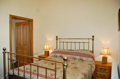 a bedroom with a bed and two lamps on night stands at Sand Dune Apartment in Barmouth in Barmouth