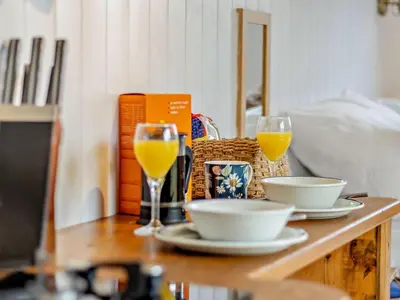 a table with a plate of food and two glasses of orange juice at 1 Bed in Llanidloes oc-56492 in Van