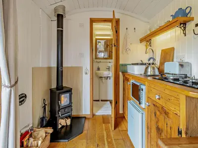 a kitchen with a wood stove in a room at 1 Bed in Llanidloes oc-56492 in Van