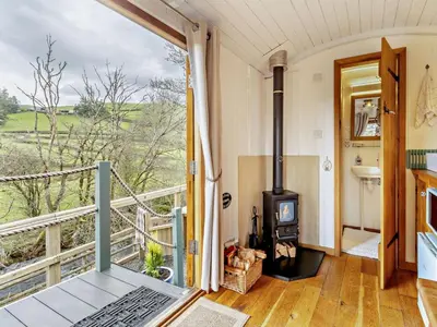 a room with a balcony with a wood stove at 1 Bed in Llanidloes oc-56492 in Van