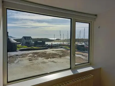 a window with a view of a construction site at Craig View Fishermans Cottage nr Harbour and Beach in Barmouth