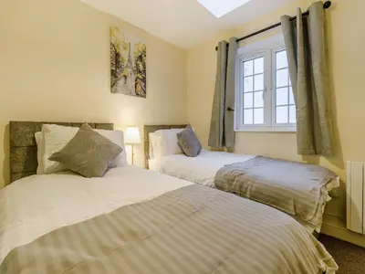 two beds in a room with a window at Brewers Cottage-Uk45454 in Montgomery