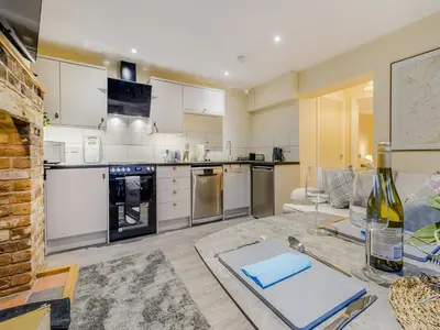 a large kitchen with white cabinets and appliances at Brewers Cottage-Uk45454 in Montgomery