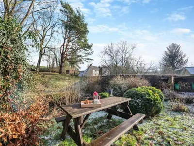 a wooden picnic table with a tray of food on it at Yr Hen Efail in Abergorlech
