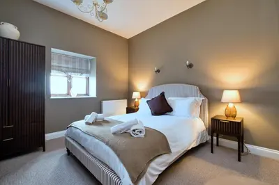 a bedroom with a bed with two towels on it at Finest Retreats - The Park in Onibury