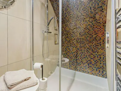 a bathroom with a shower with a glass door at 1 Bed in Llanidloes oc-81415 in Van
