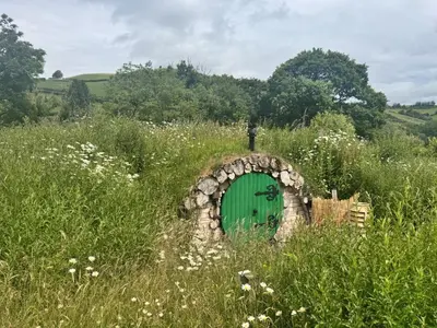 a green door in the middle of a field at 1 Bed in Llanidloes oc-81415 in Van
