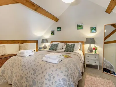 a bedroom with a large bed with towels on it at 2 Bed in Hereford oc-82095 in Byford