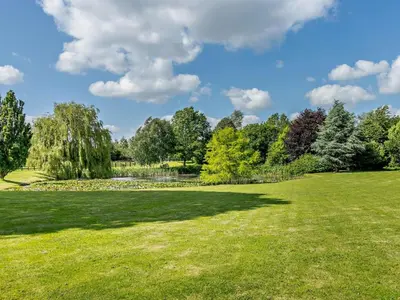 a large grassy field with trees in the background at 2 Bed in Hereford oc-82095 in Byford