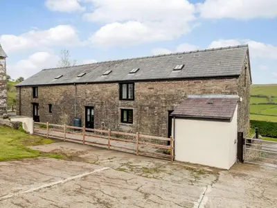 an old brick building with a white garage at 1 Bed in Brecon oc-bn034 in Cray