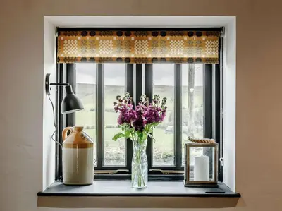 a vase of flowers sitting on a window sill at 1 Bed in Brecon oc-bn034 in Cray