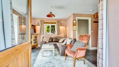 a living room with a couch and chairs at Mwsogl - Luxurious Family Fishing Lodge Near Aberaeron With Private Fishing in Cross Inn