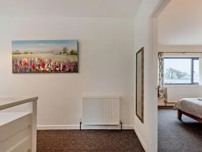 a bedroom with a painting on the wall at 5 Bed in Llanybydder oc-75907 in Llanwenog