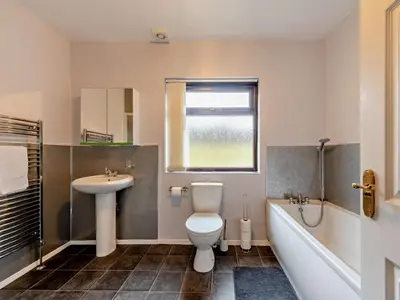 a bathroom with a toilet and a sink and a tub at 5 Bed in Llanybydder oc-75907 in Llanwenog