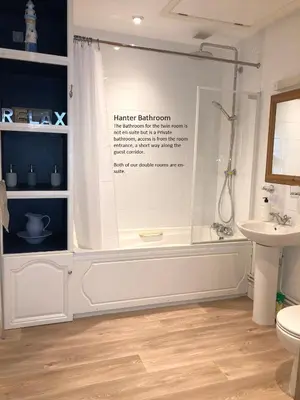 a bathroom with a shower and a toilet and a sink at Offa's Dyke Lodge B&B in Gladestry