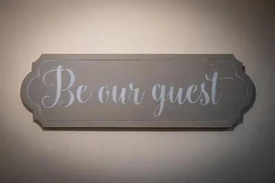 a sign that says be our guest on a wall at Town Centre Cottage 3 Bedroom inc Parking (1 car) in Shrewsbury