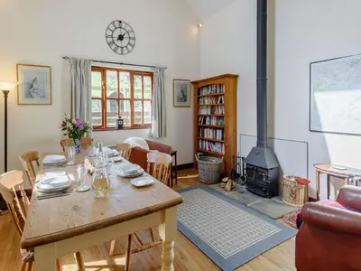 a living room with a table and a fireplace at 2 Bed in Presteigne oc-75066 in Whitton