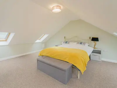 a bedroom with a bed with a yellow blanket on it at 2 Bed in Aberystwyth oc-83552 in Llanilar