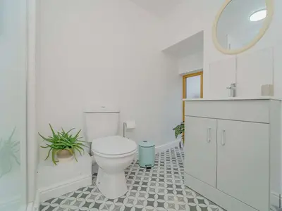 a bathroom with a toilet and a sink and a mirror at 2 Bed in Aberystwyth oc-83552 in Llanilar