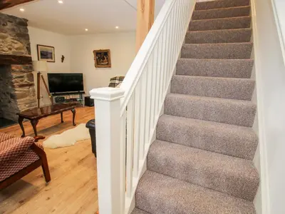a winding staircase in a home with a living room at Ty Gwyn in Welshpool