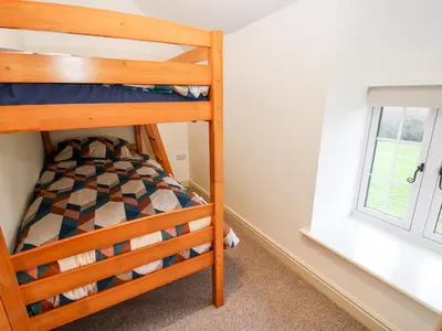 a bunk bed in a room with a window at Ty Gwyn in Welshpool