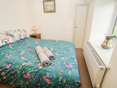 a bedroom with a bed with towels on it at Ty Gwyn in Welshpool