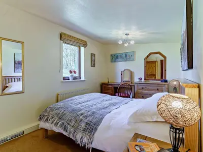 a bedroom with a bed and a desk and a mirror at 2 Bed in Lampeter oc-43293 in Tregaron