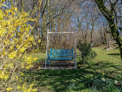 a blue bench sitting in the middle of a field at 2 Bed in Lampeter oc-43293 in Tregaron