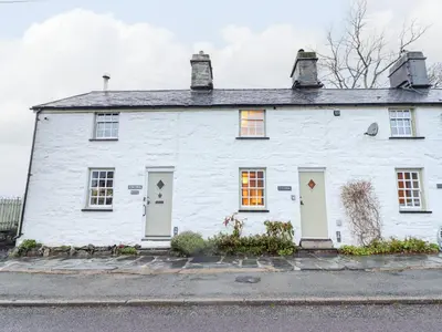 a white house with white doors and windows at Bwthyn Y Bugail in Blaenau-Ffestiniog