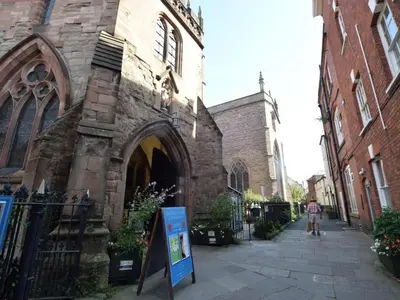 an old stone church with a sign in front of it at 1 Bed in Presteigne oc-55285 in Presteigne