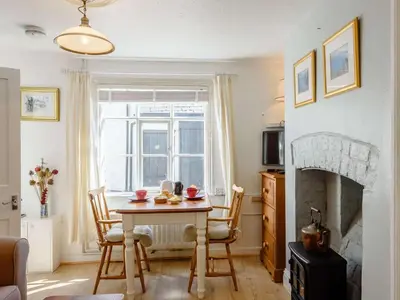 a living room with a table and a fireplace at 1 Bed in Presteigne oc-55285 in Presteigne