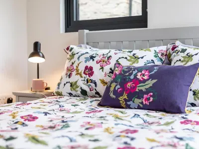 a bed with floral pillows on it with at 2 Bed in Brecon oc-59734 in Talgarth
