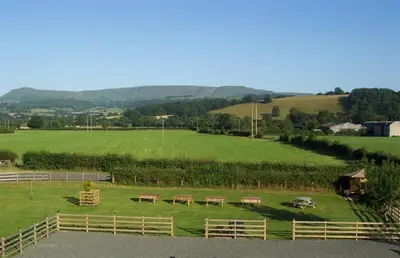 a group of benches in a field with a fence at 3 Bed in Boughrood BN370 in Llyswen