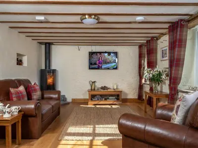 a living room with leather furniture and a flat screen tv at 1 Bed in Brecon oc-bn270 in Llansantffread