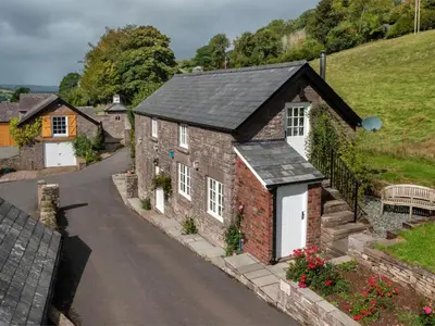 an old brick house with a black roof at 1 Bed in Brecon oc-bn270 in Llansantffread