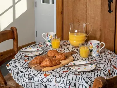 a table with a plate of croissants and orange juice at 1 Bed in Brecon oc-bn270 in Llansantffread