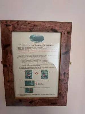 a sign in a wooden frame hanging on a wall at The Barn at the Mill in Selattyn