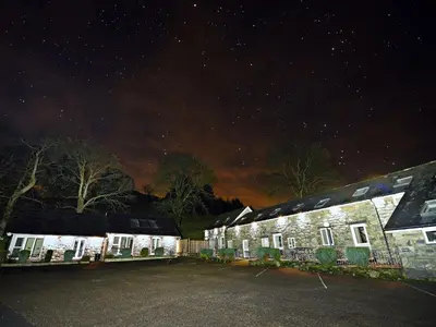 a group of buildings with a starry sky at night at 2 Bed in Llandderfel 87274 in Llandderfel