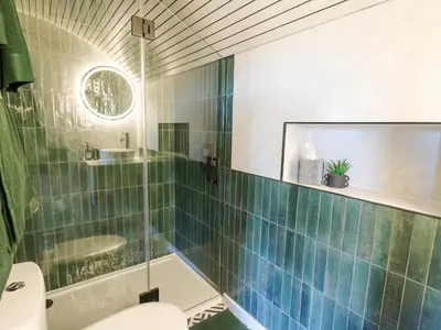 a bathroom with a glass shower and a toilet at Tan y Wawr- Onnen in Welshpool