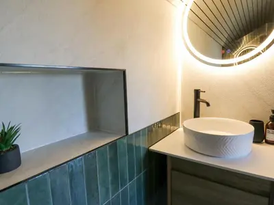 a bathroom with a white sink and a mirror at Tan y Wawr- Onnen in Welshpool