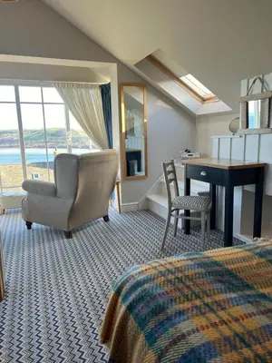 a bedroom with a bed and a desk and a chair at Y Stabl in New Quay