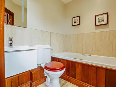 a bathroom with a toilet and a bath tub at 2 Bed in Dyffryn Ardudwy oc-89438 in Dyffryn