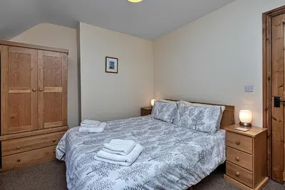 a bedroom with a bed with towels on it at Finest Retreats - Llechwedd Mawr in Talybont