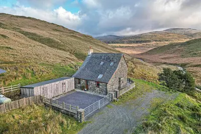 an old house in the middle of a hill at Finest Retreats - Llechwedd Mawr in Talybont