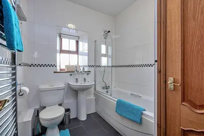 a bathroom with a toilet and a sink and a tub at Finest Retreats - Eithinog in Talybont