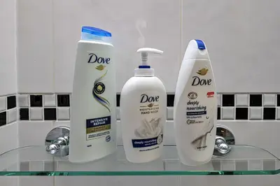 two bottles ofodorizers on a glass shelf in a bathroom at Finest Retreats - Eithinog in Talybont